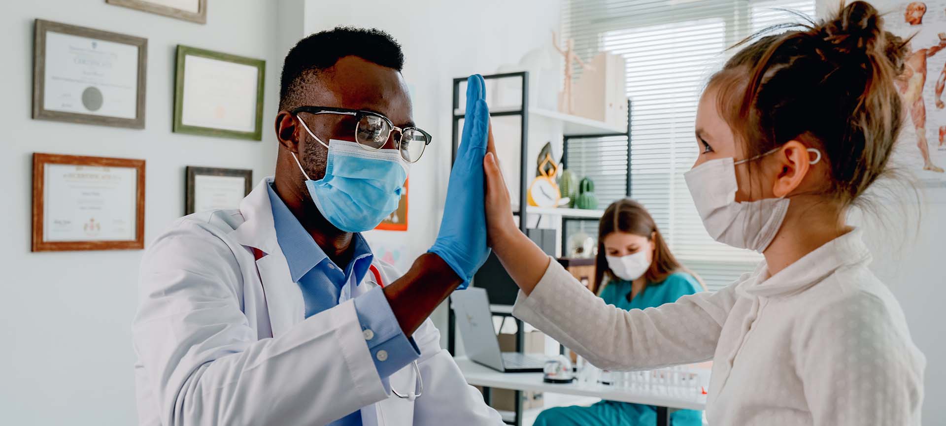 Doctor high fiving a child