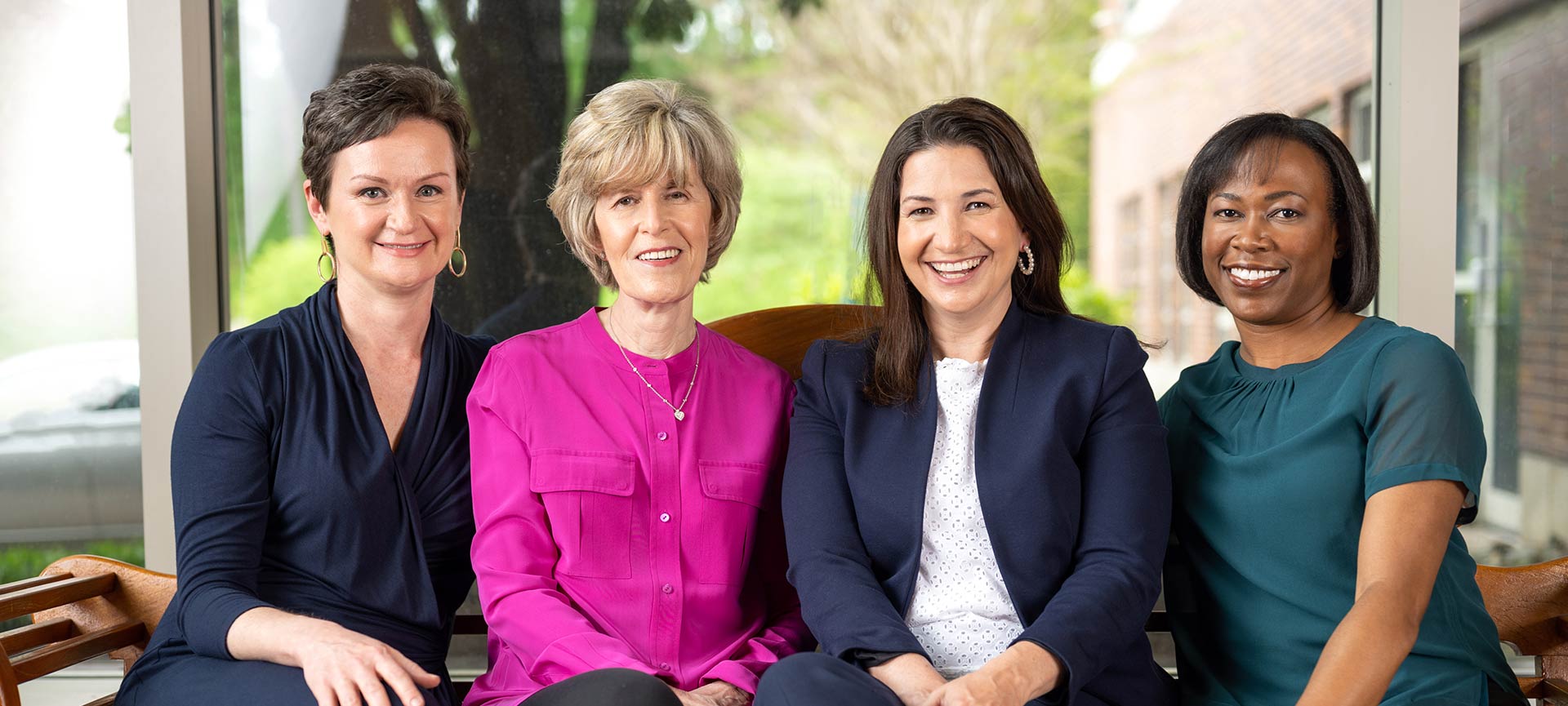 Four women smiling