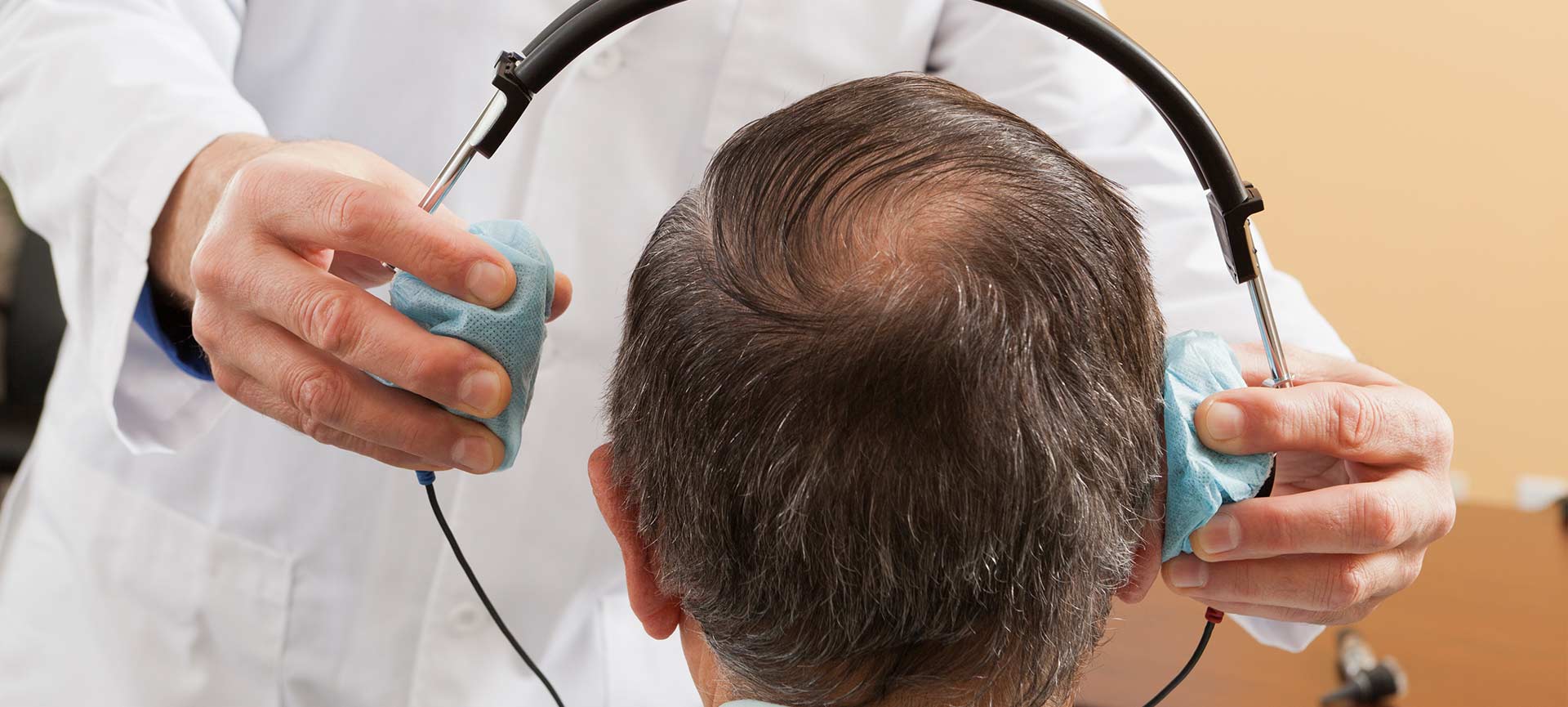 Doctor putting on headphones for patient