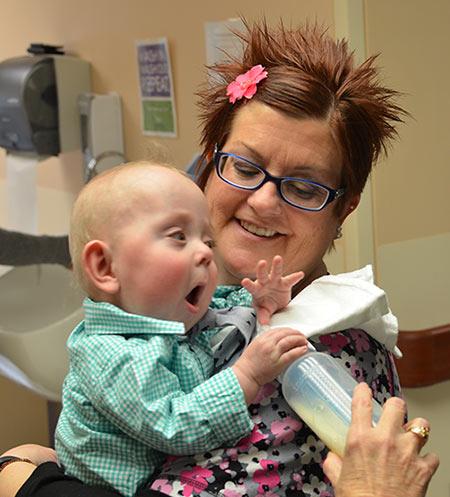 Celebrating his 1st birthday with one of his favorite nurses