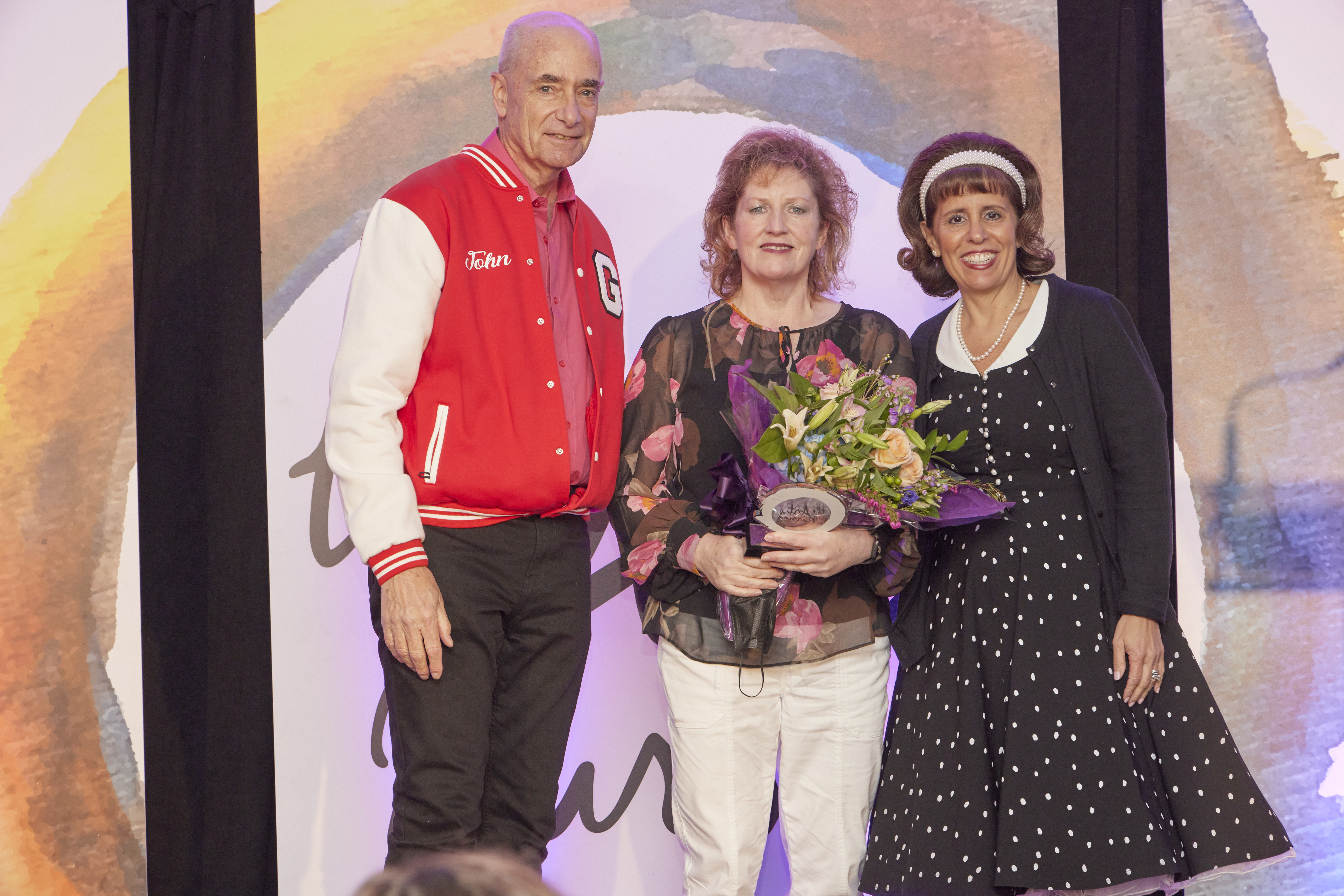 Cate O'Connor-Devlin (center) accepting an AON award.