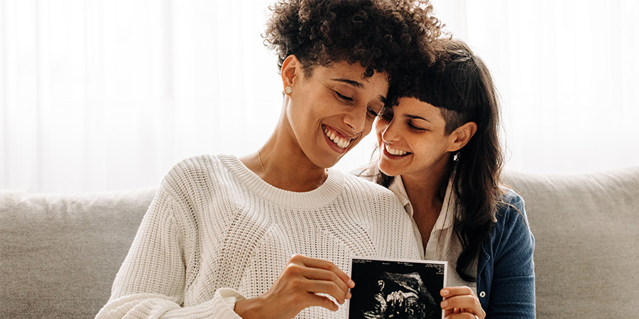 Same-sex couple celebrating pregnancy announcement