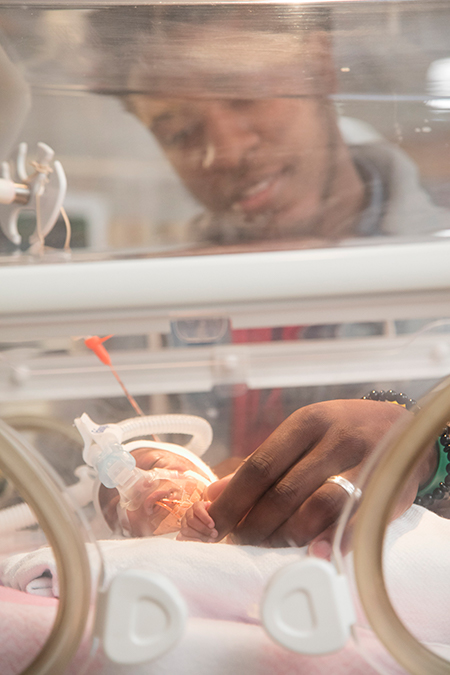 NICU father, incubator daughter