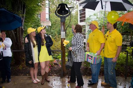 My husband and kids watch as I ring the bell.