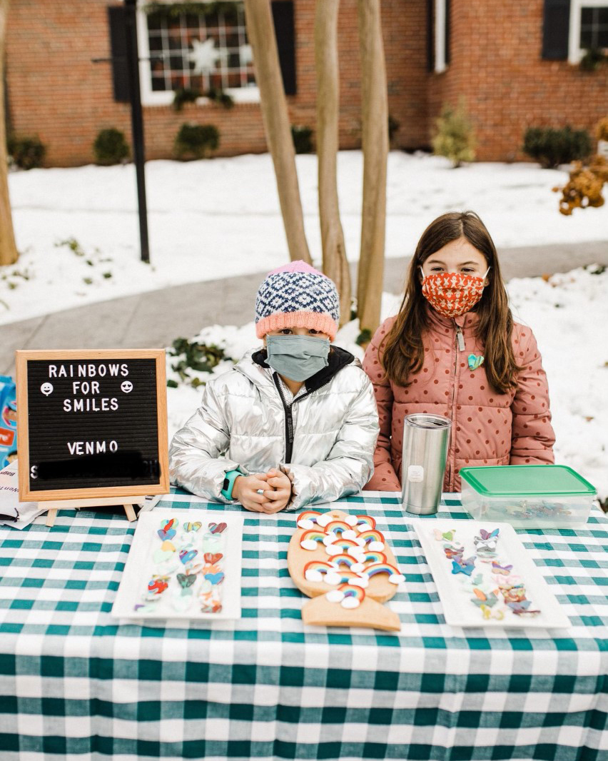 Alma (10) and Clara Boblooch (8) selling pins to benefit the Cleft Lip and Palate program